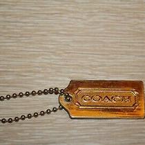 coach gold metal hang tag